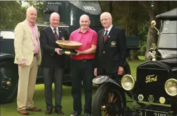  ??  ?? Artist Robert O’Connor, who sculptured the trophy, looks on as Courtown Captain John Fitzgerald presents his prize to the overall winner, Niall Slatter, with club President, George Kilbride, looking on. The quartet are pictured with the Sliabh na mBan...