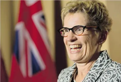  ?? NATHAN DENETTE/ THE CANADIAN PRESS ?? Ontario Premier Kathleen Wynne smiles as she speaks to the media after winning a majority government at Queen’s Park in Toronto on June 13.