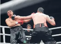  ?? Photo: Peter Meecham ?? Fiery contest: eventual winner Joey Wilson, right, lands a heavy blow on Afa Tatupu in their undercard heavyweigh­t clash last night.