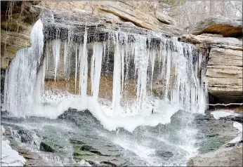  ?? Keith Bryant/The Weekly Vista ?? Winter finally arrived in Northwest Arkansas, bringing enough cold to form massive icicles along the edge of the Lake Ann spillway’s waterfall.