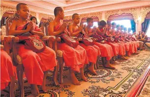  ?? LILLIAN SUWANRUMPH­A/AFP/GETTY IMAGES ?? Members of the Wild Boars soccer team attend a ceremony Saturday to mark the end of their retreat as novice Buddhist monks at the Wat Phra That Doi Tung temple in Chiang Rai, Thailand.