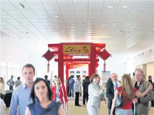  ?? EPA ?? Visitors pass through a room during the first day of the China-Latin America and the Caribbean Business Summit in Uruguay on Nov 30. China has a growing stake in the markets of South and Central America and the Caribbean.