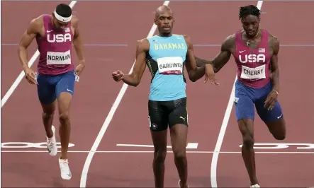  ?? CHARLIE RIEDEL — THE ASSOCIATED PRESS ?? Steven Gardiner, of Bahamas wins the gold medal ahead Michael Cherry, of United States, fourth, and Michael Norman, of United States, fifth, in the final of the men’s 400-meter at the 2020Summer Olympics on Thursday in Tokyo, Japan.