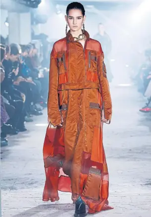  ?? ESTROP GETTY IMAGES ?? This outerwear-inspired look from the Sacai Fall 2020 runway is a deconstruc­ted flight suit made of techy looking nylon and adorned with zippered pockets.