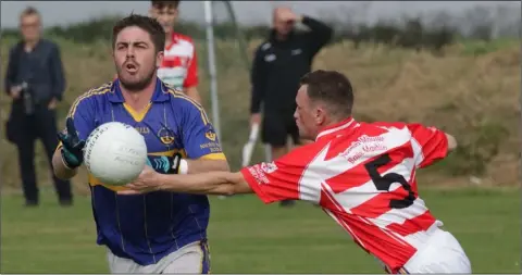  ??  ?? Conal Grant of St. Mary’s (Rosslare) dodges the challenge of Harry Kavanagh (St. Mary’s, Maudlintow­n).