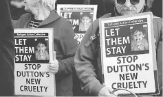  ??  ?? Refugee advocates hold signs as they protest against the detention of asylum seekers being held at Australian-run offshore detention centers located on Papua New Guinea’s Manus Island, and the South-Pacific island of Nauru, in central Sydney,...