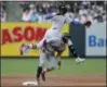  ?? JULIE JACOBSON — ASSOCIATED PRESS ?? Yankees shortstop Didi Gregorius tries to leap over Braves’ Ender Inciarte while attempting to turn a double play in the first inning of Wednesday’s game. Inciarte was forced at second, but Freddie Freeman was safe at first.