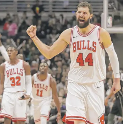  ??  ?? Nikola Mirotic celebrates after a basket in the second half Friday night in Milwaukee. The Bulls are 5- 0 since his return.
