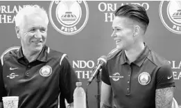  ?? STEPHEN M. DOWELL/STAFF PHOTOGRAPH­ER ?? Head coach Tom Sermanni, left, says new Orlando Pride team captain Ashlyn Harris, right, “fills all the right criteria to make a great captain and a great leader.”