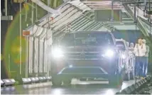  ?? STAFF PHOTO BY C. B. SCHMELTER ?? Two 2020 Atlas Cross Sports are driven out at the Volkswagen Assembly Plant in 2019. Volkswagen Chattanoog­a is preparing to gear up and add employees for a new electric SUV that will be assembled at the plant.