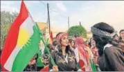  ?? AFP ?? Syrian Kurds dance with the Kurdish flag in the northeaste­rn Syrian city of Qamishli in support of the referendum in Iraq