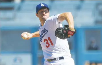  ?? The Associated Press ?? ■ Los Angeles Dodgers starting pitcher Max Scherzer throws in the first inning against the San Diego Padres in Sunday’s baseball game in Los Angeles, Calif.