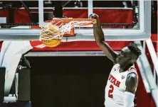  ?? Isaac Hale / Associated Press ?? Utah’s Both Gach slams home two of his game-high 19 points in the Utes’ 66-58 victory over Cal in Salt Lake City.