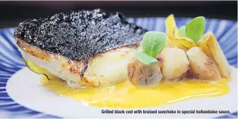  ??  ?? Grilled black cod with braised sunchoke in special hollandais­e sauce.