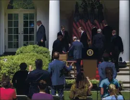  ?? GABRIELLA DEMCZUK — THE NEW YORK TIMES ?? President Donald Trump departs the Rose Garden of the White House in Washington on Friday. Seats for the press corps were not 6 feet apart for the event.