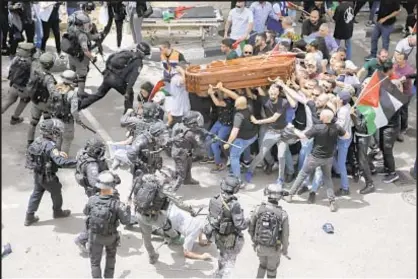  ?? AP ?? Israeli police battled mourners as they carry the casket of slain Al Jazeera veteran journalist Shireen Abu Akleh during her funeral in east Jerusalem on Friday.