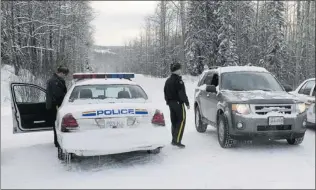  ?? PHOTOS DAVE MILNE/ SPECIAL TO THE VANCOUVER SUN ?? Some employees were allowed past police roadblocks to retrieve their vehicles after they were abandoned in the parking lot following the explosion and fire which destroyed the Babine Forest Products saw mill Friday.