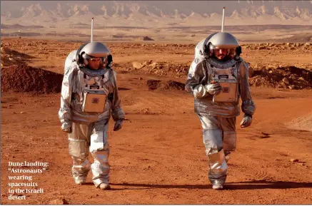  ?? PHOTO: GETTY IMAGES ?? Dune landing: “Astronauts” wearing spacesuits in the Israeli desert