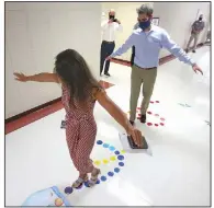  ?? (Arkansas Democrat-Gazette/Thomas Metthe) ?? Eastside Elementary School Principal Jill Fletcher shows U.S. Sen. Tom Cotton how the school’s sensory walk works during a Friday tour of the school in Cabot.