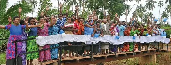  ?? Photo: Ministry of Rural, Maritime Developmen­t and Disaster Management ?? Minister of Rural, Maritime Developmen­t and Disaster Management Sakiasi Ditoka (middle) with the villagers during the opening of the newly constructe­d foot crossing in Cakaudrove on March 24, 2023.