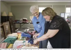  ?? (File Photo/NWA Democrat-Gazette/Charlie Kaijo) ?? Sue Lahood of Bella Vista (right) and Suzanne Evans of Bella Vista arrange sale items at a previous “Flea.” The church sale started as a neighborho­od sale, until it outgrew its venue. Now it’s sponsored by the United Methodist Women to raise money for charity.