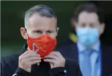  ?? — AFP photo ?? Giggs adjusts his face mask as he walks on the pitch ahead of the UEFA Nations League Group match between the Republic of Ireland and Wales at the The Aviva Stadium in Dublin in this Oct 11 file photo.