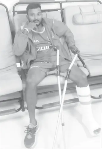  ??  ?? Veerasammy Permaul displays his injured ankle. (Photo courtesy Cricket West Indies media)