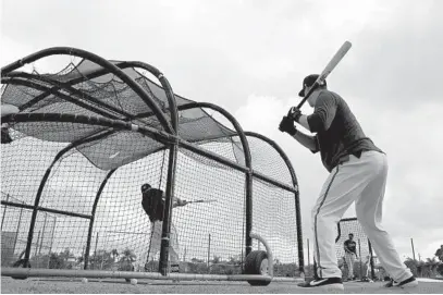  ?? LLOYD FOX/BALTIMORE SUN ?? Catcher Adley Rutschman waits on deck for his turn in the batting cage at the Ed Smith Stadium complex.