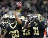  ?? BILL FEIG — THE ASSOCIATED PRESS ?? New Orleans Saints cornerback Marshon Lattimore (23) celebrates an intercepti­on with cornerback Ken Crawley (20) and cornerback Chris Banjo (31) in the first half of an NFL football game in New Orleans, Sunday.