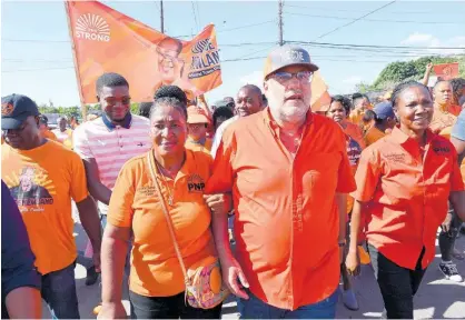  ?? FILE ?? Mark Golding is flanked by PNP councillor candidates Louise Newland (left) and Sarah Marshall in his constituen­cy of St Andrew South.