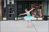  ??  ?? North Pointe Ballet dancer Laura Hankey performs on Broadway Ave during Block Party.