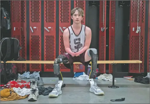  ??  ?? South Central High School’s Landis Sims poses in the locker room in Elizabeth, Ind. He was born without hands and without legs below the knee. (The Indianapol­is Star/Mykal McEldowney)