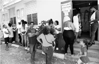  ?? RICARDO MAKYN/ MULTIMEDIA PHOTO EDITOR ?? People wait outside Alligator Pond Primary School to cast their vote in February’s local government elections.