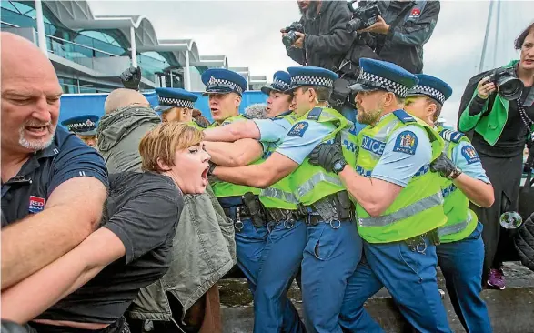  ??  ?? Police, protesters, and forum attendees jostled outside the ANZ Events Centre during an arms conference on Wednesday.