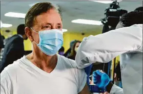  ?? Brad Horrigan / Associated Press file photo ?? Gov. Ned Lamont receives his first dose of Pfizer's COVID-19 vaccine at The First Cathedral church in Bloomfield on Feb. 16, 2021.