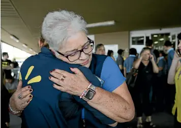  ?? AP ?? Walmart employees comfort one another after a shooter opened fire at their store in El Paso, Texas.