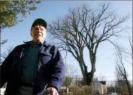  ?? STEVEN SENNE — THE ASSOCIATED PRESS FILE ?? Frank Knight, 101, of Yarmouth, Maine, stands in front of an elm tree known as “Herbie” in Yarmouth. Knight took care of the tree for about 50 years while working as the Yarmouth tree warden. The tree, estimated to be 217years old, was cut down after suffering numerous bouts of Dutch elm disease. “Herbie” may be gone, but he’ll live on in cloned trees that are being made available to the public.