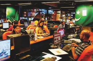  ?? Reuters ?? Employees at Geo News television channel in Karachi. The station was taken off ■ the air across much of the country at the end of March.