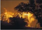  ?? KARL MONDON — STAFF PHOTOGRAPH­ER ?? FIRES » Homes burn in Winters on Wednesday in the LNU Lightning Complex Fire.