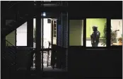  ?? JONAS WALZBERG — DPA VIA AP ?? Police officers walk through a Jehovah’s Witness building in Hamburg, Germany, on Thursday after a mass shooting.