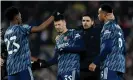  ?? Photograph: Michael Regan/Getty Images ?? Mikel Arteta congratula­tes his Arsenal players on the Anfield pitch after they kept Liverpool at bay despite playing with 10 men for over an hour.