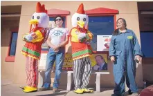  ?? MARLA BROSE/JOURNAL ?? Tom Hudak, second from left, poses for a photograph while dressed as Walter White between the Los Pollos Hermanos mascots in front of Twisters on Isleta Boulevard. The restaurant was converted to Los Pollos Hermanos from “Breaking Bad” on Saturday....
