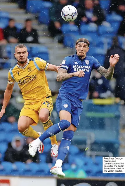  ?? ?? Reading’s George Puscas and Cardiff’s Aden Flint go up for the ball in Saturday’s clash in the Welsh capital.