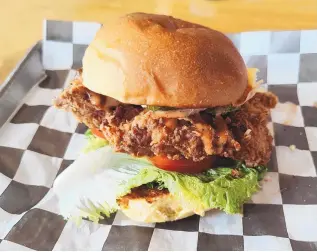 ?? RICHARD S. DARGAN/FOR THE JOURNAL ?? Stackers’ Crispy Chicken Sandwich consists of a fried chicken breast with lettuce, tomato and pickles on a brioche bun.