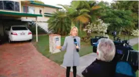  ?? ?? LOGANLEA, Australia: A television reporter does a live report while waiting for the return of Schapelle Corby to her mother’s home yesterday. — AFP