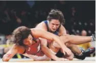  ??  ?? Adeline Gray, top, wrestles in the Pan Am Games in Canada last month. Associated Press file