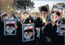  ?? Picture: AFP/ MOHAMMAD ALI MARIZAD ?? SHOW OF STRENGTH: Pro-government demonstrat­ors hold posters of Iran’s supreme leader, Ayatollah Ali Khamenei, left, and founder of the Islamic republic Ayatollah Ruhollah Khomeini