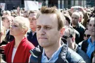  ?? AP/PAVEL GOLOVKIN ?? Russian opposition leader Alexei Navalny (center) takes part in a rally in Moscow on Sunday.