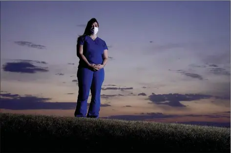  ?? CHARLIE RIEDEL — THE ASSOCIATED PRESS ?? Emergency room nurse L’Erin Ogle stands at dawn before starting her 12-hour shift at a nearby hospital Tuesday, March 9, 2021, in Overland Park, Kan.