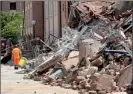  ??  ?? A rescue worker walks past a collapsed building, after an earthquake, in Cavezzo near Modena May 29, 2012.(AFP)